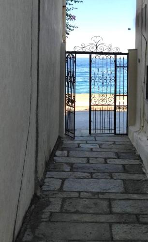 a view of the beach from a gate with the ocean at Armiriki Seafront House in Afissos