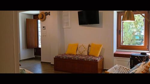 a living room with a couch and a window at Armiriki Seafront House in Afissos