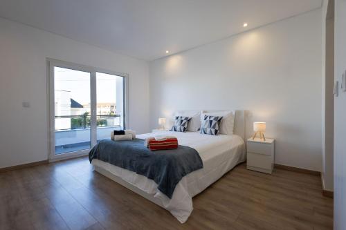 Ένα ή περισσότερα κρεβάτια σε δωμάτιο στο Casa Férias com Piscina Aquecida e Suítes Privadas