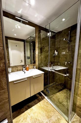 a bathroom with a sink and a shower at Annabelle Studio in Batumi