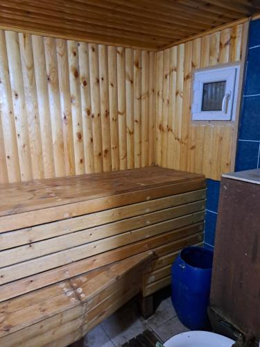 a wooden sauna with a toilet in a room at Дача Байтик in Tash-Tyube
