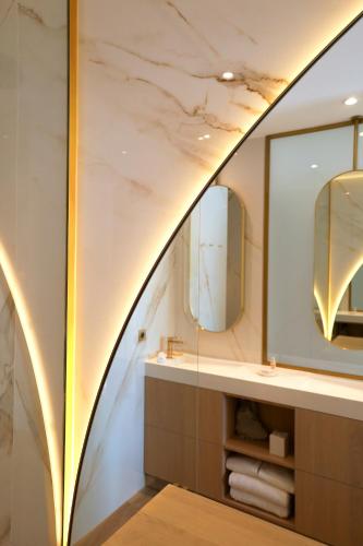 a bathroom with a sink and a mirror at Hôtel Marinca & Spa in Olmeto