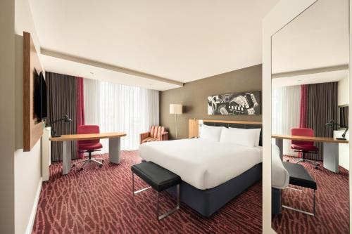 a hotel room with a bed and a desk at Holiday Inn Manchester-Mediacityuk by IHG in Manchester
