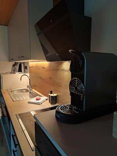 a kitchen with a black coffee maker on a counter at Ferienwohnung Hinteregghof in Hart im Zillertal