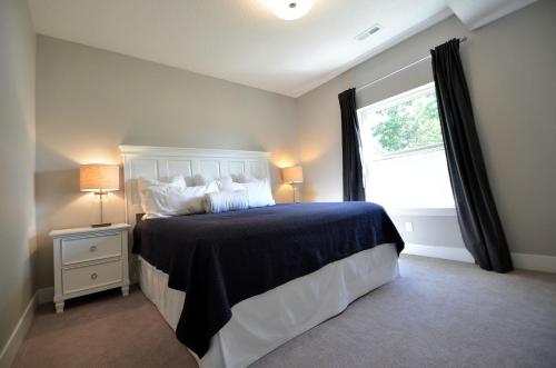 a bedroom with a large bed and a window at Comfortable and Modern Cabin Rental on Lake Red Rock near Pella, Iowa in Pella