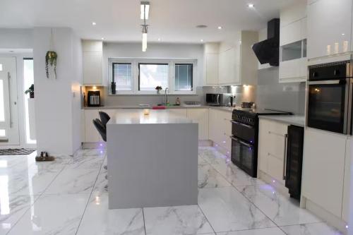 a kitchen with white cabinets and a white counter top at Falcon house 7 bedrooms in Hawley