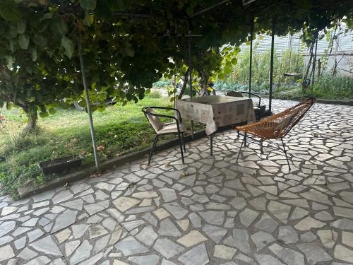a table and chairs on a patio under an umbrella at Rooms Struga in Struga