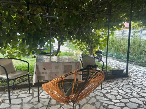 a patio with chairs and a table and a tree at Rooms Struga in Struga