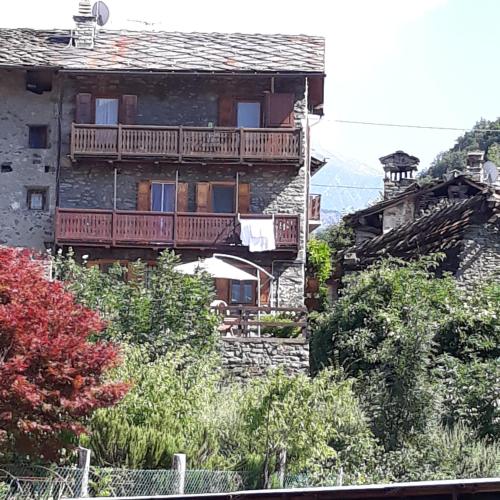 a building with a balcony on the side of it at il Battito in Saint Vincent