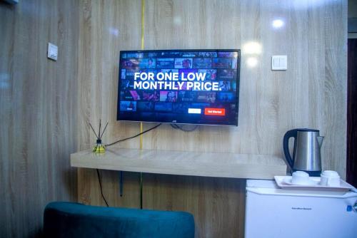 a flat screen tv hanging on a wall at Ontario Suites in Lagos