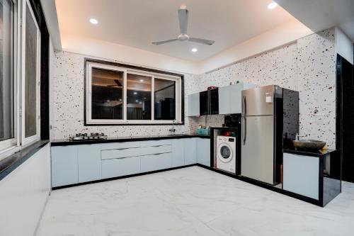 a kitchen with a refrigerator and a washer and dryer at Viva villa by Dancenter in Malavli