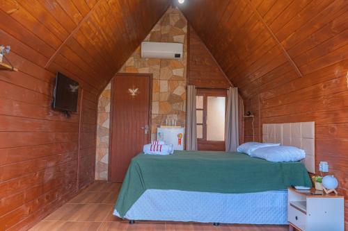 a bedroom with a bed in a wooden room at Oceana Suites Aracaju in Aracaju