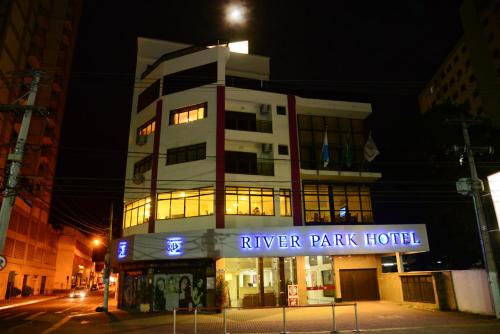 a building with a sign that reads river park hotel at River Park Hotel in Resende