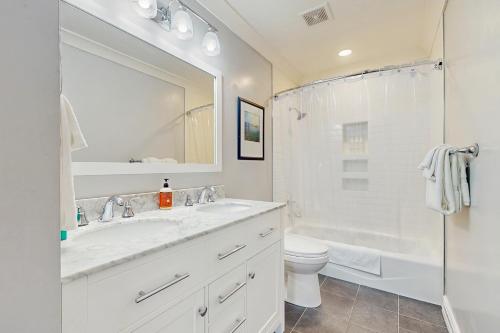 a bathroom with a sink and a toilet and a shower at Saltwater Shoreline in Shoreline