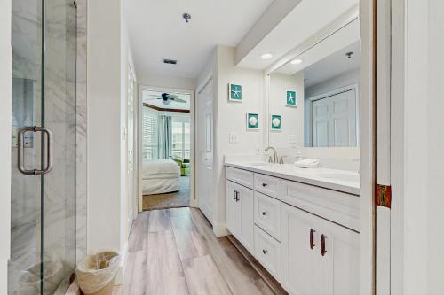 a white bathroom with a sink and a shower at High Pointe W31 - Gulf Front Condo in Inlet Beach