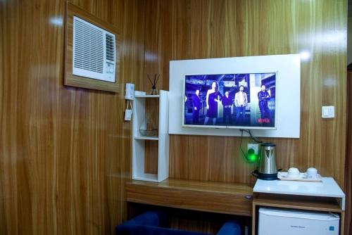 a flat screen tv on a wall in a hotel room at Ontario Suites in Lagos