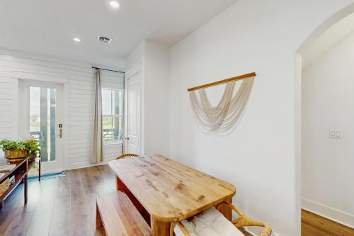 a living room with a wooden table and a couch at Fairway to Heaven in Port Aransas