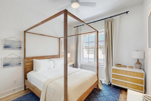 a bedroom with a canopy bed and a window at Fairway to Heaven in Port Aransas