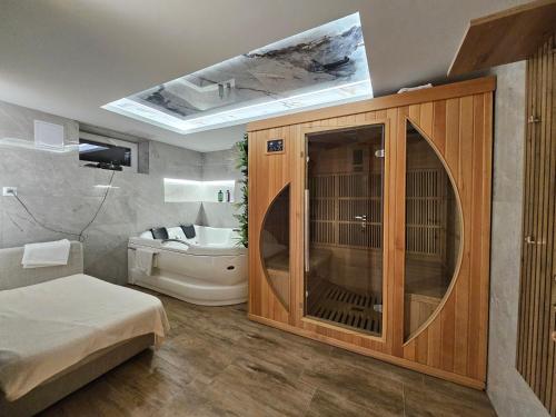 a bathroom with a large wooden cabinet and a sink at Wellness Toliar Tatry in Stará Lesná