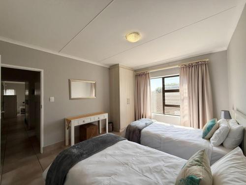 a hotel room with two beds and a fireplace at Sandy Shore Escape - Diaz in Mossel Bay