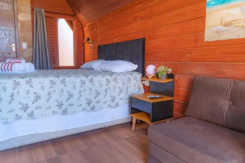 a bedroom with a bed and a couch at Oceana Suites Aracaju in Aracaju