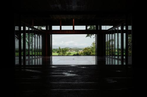an empty room with a large open door with a view at Sataa Resort Nan in Nan