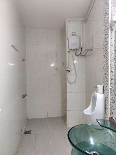 a bathroom with a glass sink and a shower at Myfriend Hostel in Ho Chi Minh City