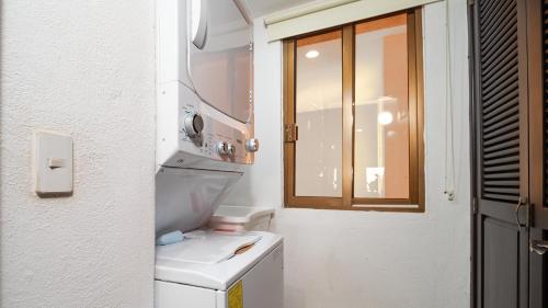 a small bathroom with a sink and a window at Princesa De Penasco in Punta Penasco New