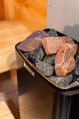 a black container with rocks and meat in it at Apartments24 Black 1903 in Rakvere