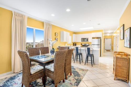 a dining room and kitchen with a table and chairs at Marlin Key 3A in Orange Beach