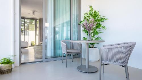 a balcony with a table and chairs and plants at Salt and Sand in Wilderness