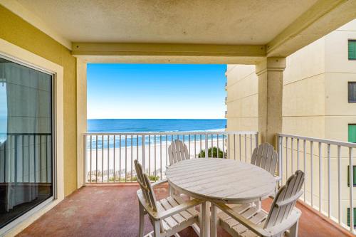 a table and chairs on a balcony with a view of the ocean at Marlin Key 3A in Orange Beach