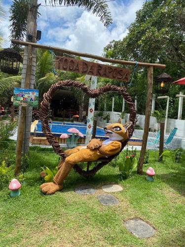 a sign with a large animal sitting in a chair at Chalé refúgio das raposas in Meruoca