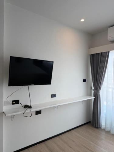 a flat screen tv on a white wall at Jellyfish Residence Patong in Patong Beach