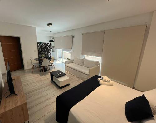 a bedroom with a bed and a living room at Sucre Suites in Buenos Aires