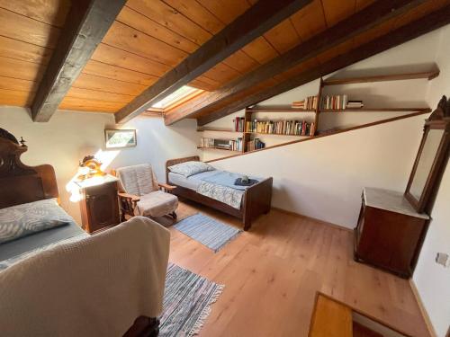 a attic room with a bed and a couch at House Santa Chiara Istria in Lanišće