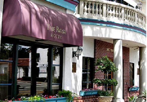 a facade of a building with a purple awning at The Rose Hotel in Pleasanton