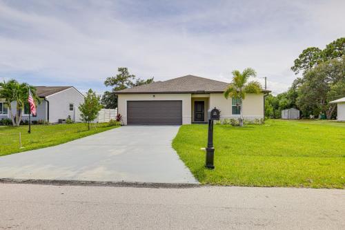 a house with a parking meter in front of a driveway at Beach-Hop and Golf! Port St Lucie Apt with Shared Yard in Eden