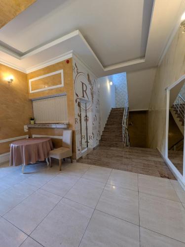 a room with a staircase and a table and a stair case at Rivera Raška 