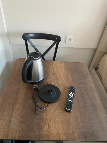 a table with a lamp and a remote control on it at HOmE SUITE in Istanbul