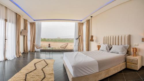 a bedroom with a bed and a large window at Life resort Marrakech 