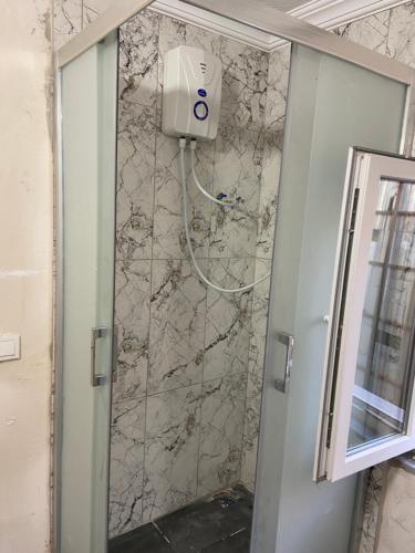 a shower in a bathroom with a stone wall at HOmE SUITE in Istanbul