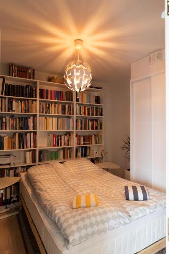 a bedroom with a large bed with book shelves at Loimu Arctic Home in Rovaniemi