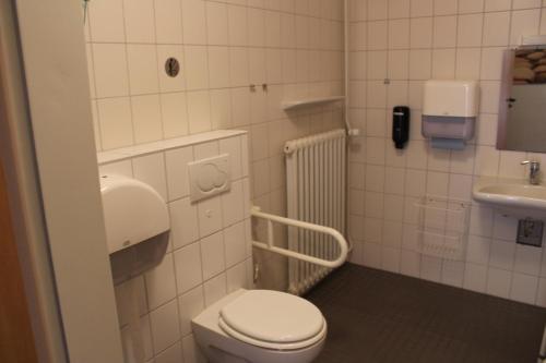 a small bathroom with a toilet and a sink at Jugendhaus West in Spiekeroog