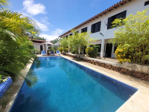a swimming pool in front of a house at Casa Caribe el Yaque in El Yaque