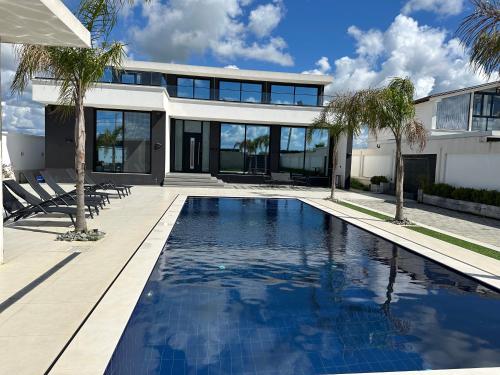 an exterior view of a house with a swimming pool at La Mirage Villa in Rrushkull