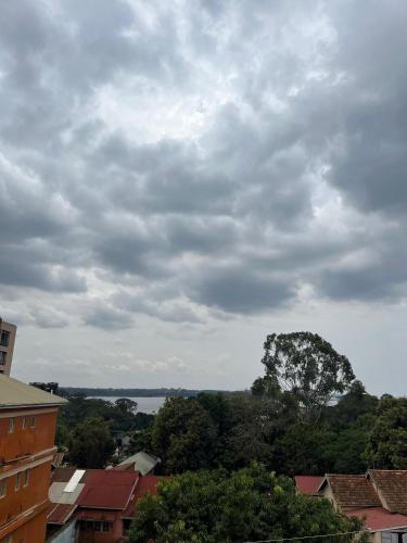 a cloudy sky with a view of a city at 1 minute walk to Victoria Mall in Entebbe