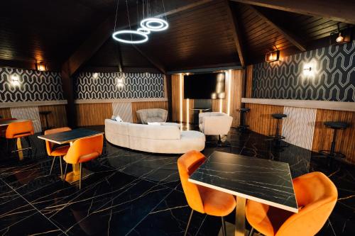 a room with a couch and a table and chairs at Heritage Park Pontypridd, Trademark Collection by Wyndham in Pontypridd