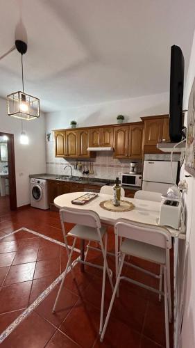 a kitchen with a white table and chairs in it at Casa Ramos in Arrecife