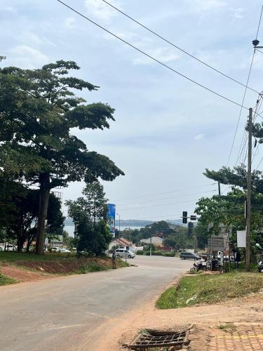 an empty street with a traffic light and trees at Hidden beautiful Modern Apartment in Entebbe